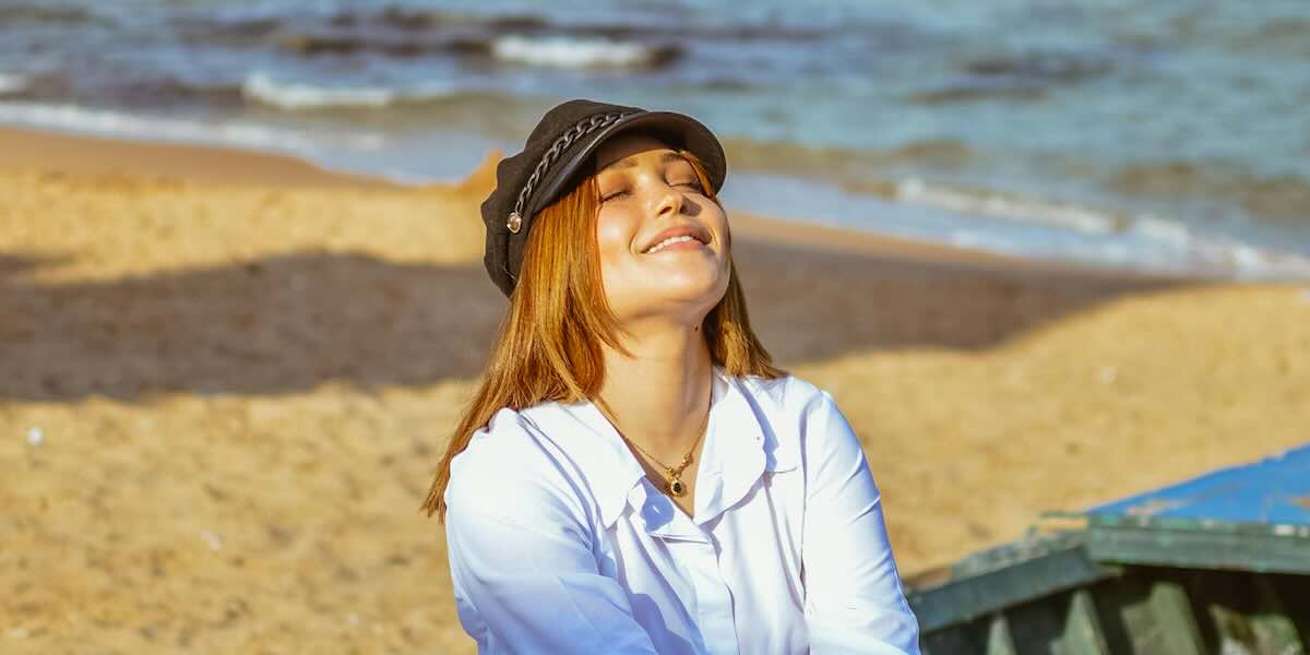 Respiro Originario e Benessere Fisico Donna che pratica il Respiro Originario in spiaggia, benessere fisico